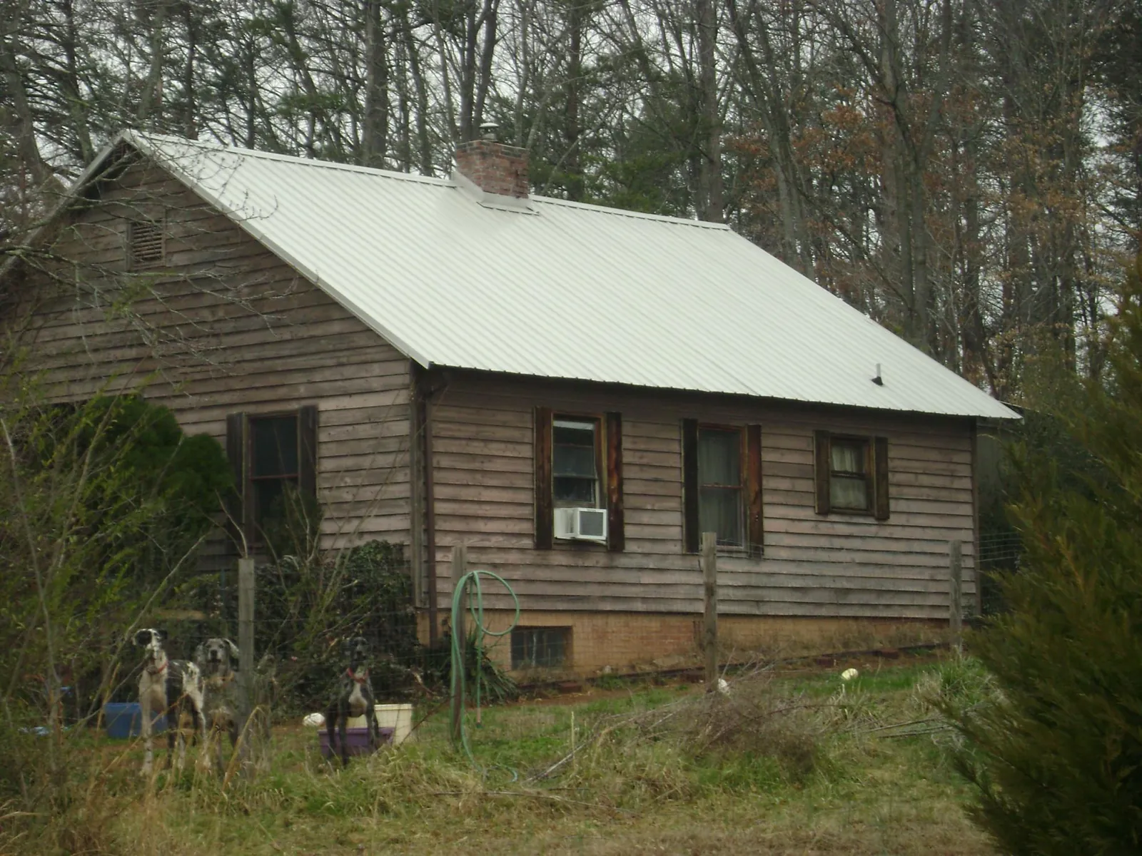 White metal roof on an old wood sided farmhouse, from a Metal Roof Installation job in West Henrietta